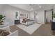 Spacious main bedroom with modern ceiling fan, plush rug, and ensuite bath offers comfort and style at 30 Hilltop Crest St, Henderson, NV 89011