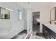 Modern bathroom featuring a glass shower with marble tile, and a black vanity with a white countertop at 3047 Van Buskirk Cir, Las Vegas, NV 89121