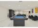 Game room with a sleek pool table, comfortable seating, and seamless flow into the adjacent living spaces at 3047 Van Buskirk Cir, Las Vegas, NV 89121