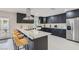 Modern kitchen with dark cabinetry, stainless steel appliances, and a large island with counter seating at 3047 Van Buskirk Cir, Las Vegas, NV 89121
