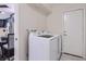 Bright laundry area featuring modern washer and dryer with easy access to the kitchen and back door at 3047 Van Buskirk Cir, Las Vegas, NV 89121
