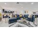 Spacious living room with a large sectional sofa, stylish decor, and seamless flow into the kitchen and game room at 3047 Van Buskirk Cir, Las Vegas, NV 89121