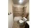 Bathroom with tub-shower combo, tiled walls, and stylish fixtures at 3278 Liahona Way, Las Vegas, NV 89121