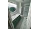 Bathroom with green vanity, marble counters, and glass enclosed shower at 3278 Liahona Way, Las Vegas, NV 89121