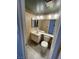Well-lit half bathroom with mirror, vanity and toilet at 3278 Liahona Way, Las Vegas, NV 89121