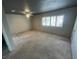 Carpeted bedroom with dark ceiling, ceiling fan, and window at 3278 Liahona Way, Las Vegas, NV 89121