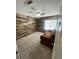 Bedroom with wood accent wall, carpet, ceiling fan, and window at 3278 Liahona Way, Las Vegas, NV 89121