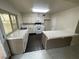 Clean kitchen with tiled countertops, and island at 3278 Liahona Way, Las Vegas, NV 89121