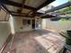 Covered patio with tiled floor, ceiling fan, partial shade, and access to house at 3278 Liahona Way, Las Vegas, NV 89121