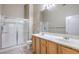 Bathroom featuring double sink vanity, shower with glass door and tile floors at 3351 Indian Shadow St # 204, Las Vegas, NV 89129