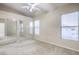 Spacious carpeted bedroom features a ceiling fan and mirrored closet doors at 3351 Indian Shadow St # 204, Las Vegas, NV 89129