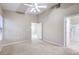 Carpeted bedroom with ceiling fan, neutral walls and ensuite bathroom access at 3351 Indian Shadow St # 204, Las Vegas, NV 89129
