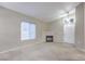 Spacious living room featuring a fireplace, vaulted ceiling, and large windows at 3351 Indian Shadow St # 204, Las Vegas, NV 89129