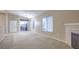 Bright living room with neutral carpet, fireplace, and access to outdoor balcony at 3351 Indian Shadow St # 204, Las Vegas, NV 89129