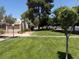 Exterior shot of a single story home, showcasing a well-manicured green lawn and mature trees at 3368 Saddleback Ct, Las Vegas, NV 89121