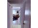 Hallway leading to a brightly lit living room with cozy seating and tile flooring at 3368 Saddleback Ct, Las Vegas, NV 89121