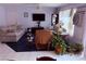 Bright living room with floral sofa, ceiling fan, and natural light at 3368 Saddleback Ct, Las Vegas, NV 89121