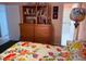 Bedroom features floral bedding, a dresser, and ensuite bathroom view at 3368 Saddleback Ct, Las Vegas, NV 89121