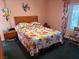 Comfortable bedroom with colorful floral bedding, bright windows and wooden headboard at 3368 Saddleback Ct, Las Vegas, NV 89121