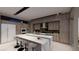 Modern kitchen with a large marble island, stainless steel appliances, and custom cabinetry at 7047 Nomi Ct, Las Vegas, NV 89120