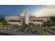 Stunning modern home with desert landscaping, unique architectural design, and elegant exterior lighting at 3530 Cosima Ln, Las Vegas, NV 89120
