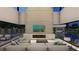 Open-concept living area with fireplace, modern furnishings, and an amazing view of the pool and landscaping at 3530 Cosima Ln, Las Vegas, NV 89120