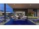 Inviting outdoor living space with pool, lounge seating, fire pit, and views into the beautifully designed home at 3530 Cosima Ln, Las Vegas, NV 89120