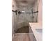 This bathroom features a frameless glass shower with a pebble floor and elegant marble accents, complemented by a modern vanity at 3900 San Angelo Ave, Las Vegas, NV 89102