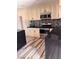 Modern kitchen with sleek black countertops, stylish backsplash, and stainless steel appliances at 3900 San Angelo Ave, Las Vegas, NV 89102