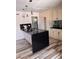Contemporary kitchen with black countertops, tile backsplash, and a convenient kitchen island at 3900 San Angelo Ave, Las Vegas, NV 89102