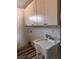 The laundry room includes overhead cabinets, a utility sink, and modern fixtures for efficient cleaning and organization at 3900 San Angelo Ave, Las Vegas, NV 89102