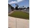 Landscaped backyard featuring lush green grass, secured with a white fence for added privacy at 3900 San Angelo Ave, Las Vegas, NV 89102