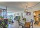 Inviting living room with dining area, large window, and access to the kitchen; perfect for modern living at 3930 University Center Dr # 706, Las Vegas, NV 89119