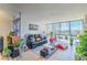 Bright living room featuring tile flooring, a comfortable couch, and many plants at 3930 University Center Dr # 706, Las Vegas, NV 89119