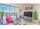 Bright living room with tile floors, large windows, and cozy decor at 3930 University Center Dr # 706, Las Vegas, NV 89119