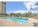 Large community pool and lounge area provide a relaxing oasis with green landscaping at 3930 University Center Dr # 706, Las Vegas, NV 89119