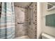 Walk-in shower features updated showerhead, grab bar, and decorative tile trim at 3930 University Center Dr # 706, Las Vegas, NV 89119