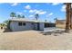 Rear view of a single story home with a graveled yard and an enclosed sunroom at 4301 San Joaquin Ave, Las Vegas, NV 89102