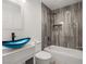 Stylish bathroom featuring a unique blue glass bowl sink and a gray tiled shower at 4301 San Joaquin Ave, Las Vegas, NV 89102