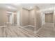 Spacious hallway featuring wood-look flooring, fresh paint, and multiple access doors at 4301 San Joaquin Ave, Las Vegas, NV 89102