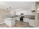 Modern kitchen with white cabinets, granite countertops, stainless appliances, and hardwood floors at 4301 San Joaquin Ave, Las Vegas, NV 89102