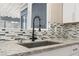 Close-up of kitchen sink, granite countertop, tiled backsplash, and modern faucet at 4301 San Joaquin Ave, Las Vegas, NV 89102