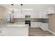 Bright kitchen features white cabinetry, granite countertops, mosaic backsplash, and stainless steel appliances at 4301 San Joaquin Ave, Las Vegas, NV 89102
