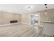 Open concept floor plan with fireplace, hardwood floors, sliding door, and adjacent kitchen at 4301 San Joaquin Ave, Las Vegas, NV 89102