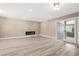 Large open room with fireplace, hardwood floors, and sliding door to backyard at 4301 San Joaquin Ave, Las Vegas, NV 89102