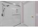 Bathroom boasts frameless glass shower with rainfall shower head and tiled walls at 4604 Barnes Ct, Las Vegas, NV 89147