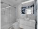 Modern bathroom features floating vanity, vessel sink, glass enclosed shower with marble tile surround at 4604 Barnes Ct, Las Vegas, NV 89147