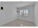 Minimalist bedroom with white walls, white trim, tile floor and window with shutter blinds at 4604 Barnes Ct, Las Vegas, NV 89147