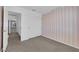 Bedroom with neutral carpet, pink and white striped accent wall, and closet with sliding doors at 4604 Barnes Ct, Las Vegas, NV 89147