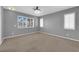 Bedroom features large windows with shutters, plush carpet, and modern lighting at 4604 Barnes Ct, Las Vegas, NV 89147